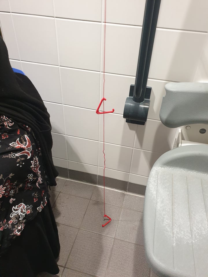 Red emergency cord hanging freely to the floor