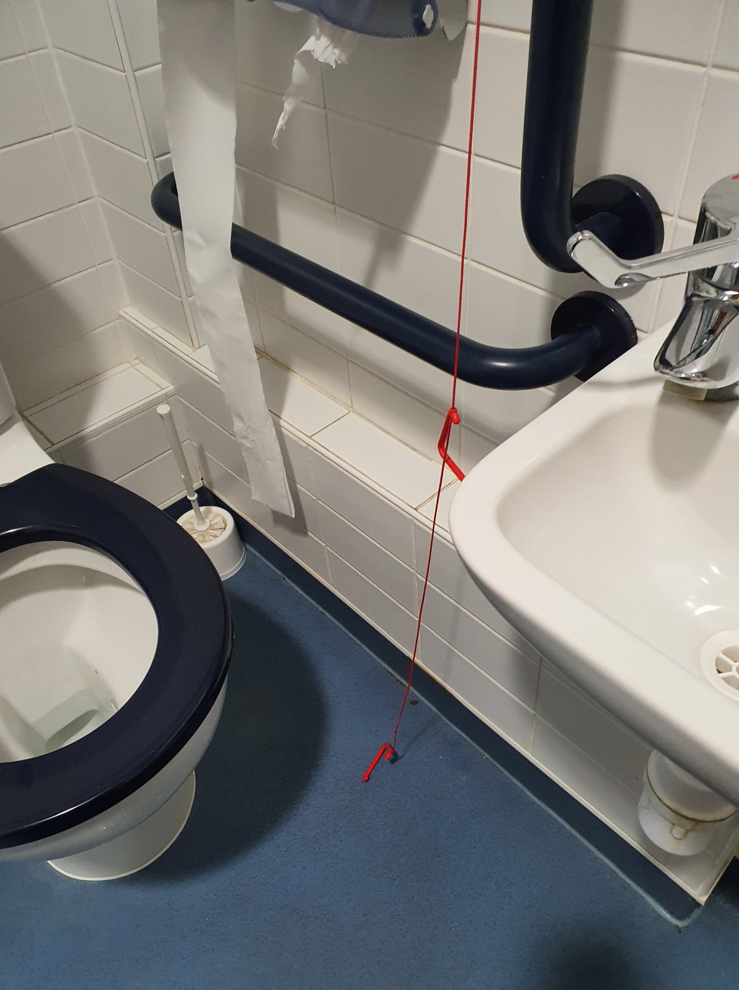 Red emergency cord hanging freely to the floor