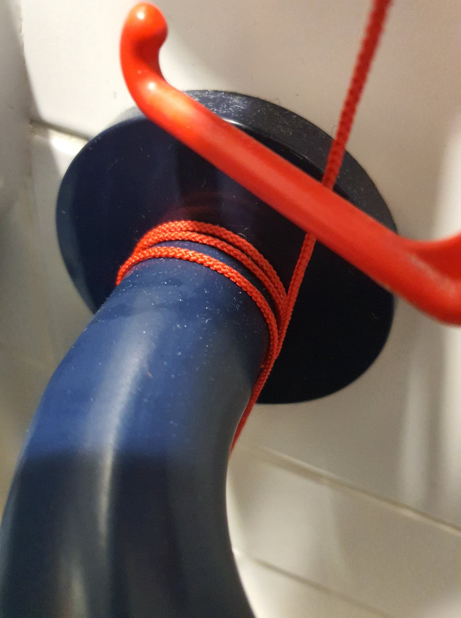 Red emergency cord wrapped around handrail