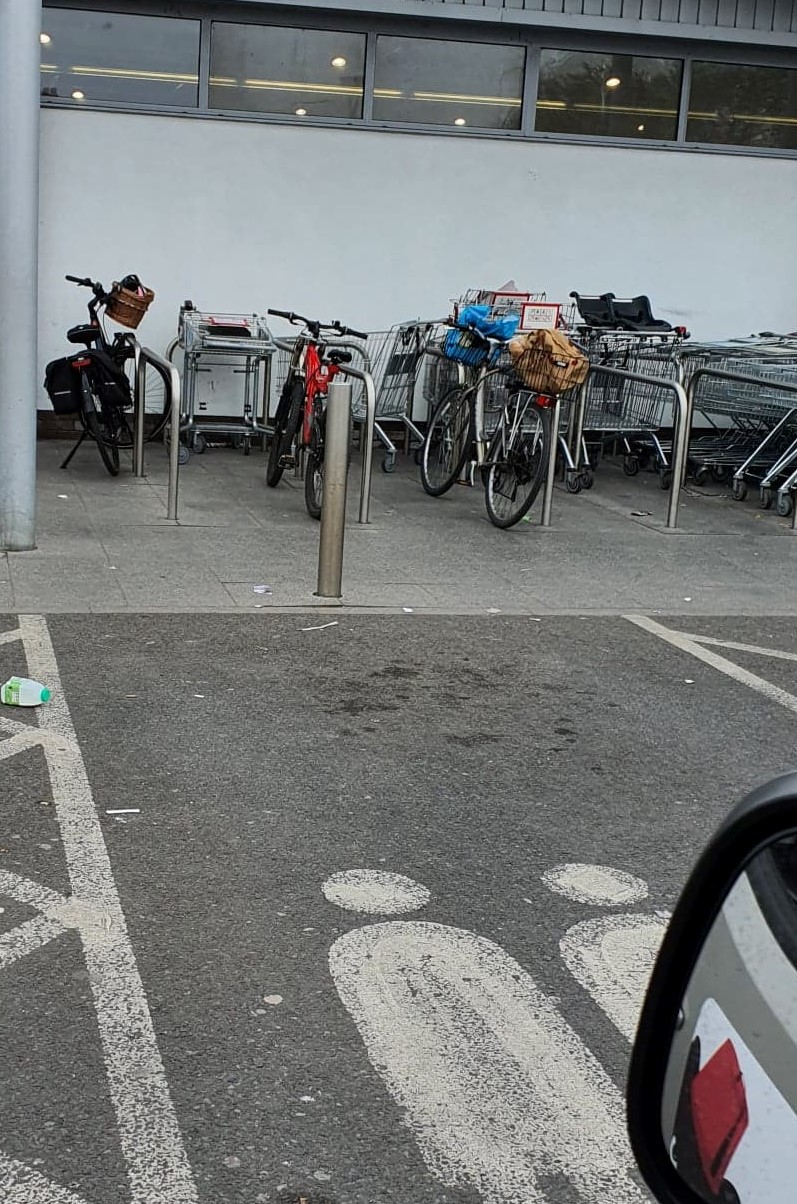 Bikes, bollards and trolleys behind parking space access