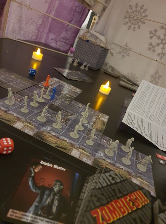 Board game inside blanket fort with candles