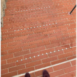 A picture of a brick staircase, looking like a flat surface with occasional anti-slip stair nosing