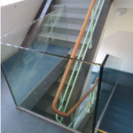 An internal staircase with a mezzanine level added with a glass balustrade.